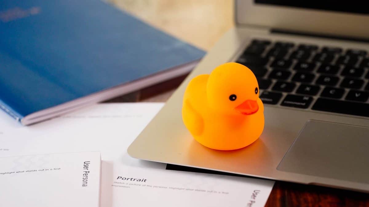 a rubber rubber ducky sitting on top of a laptop