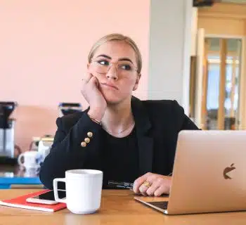 woman in black long sleeve shirt using macbook